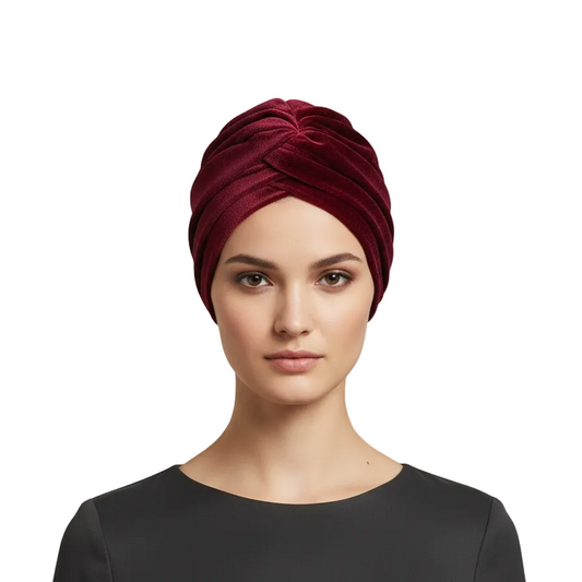Woman wearing a red turban against a white background