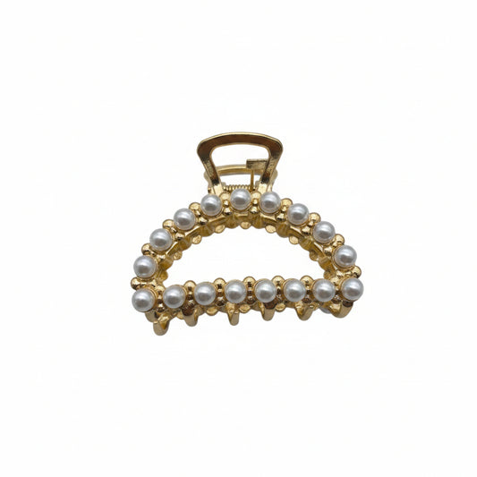 A gold-colored hair clip featuring a strass (rhinestone) design.