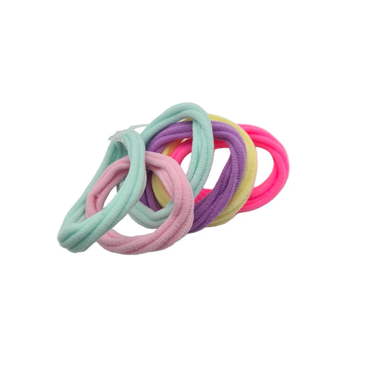 A collection of colorful children's hair elastics, arranged in a spiral on a light background.