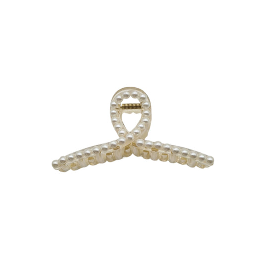 A white hair clip with a heart-shaped ornament and pearl accents