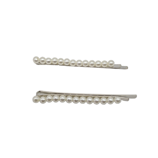 Two pearl hair pins on a white background