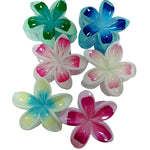 Load image into Gallery viewer, Colorful flower-shaped objects on a white card with a wooden surface underneath.
