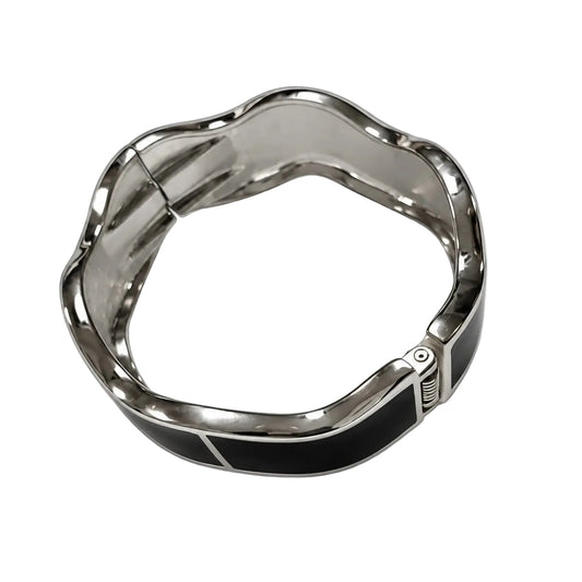 Women's black and silver-tone wavy hinged bangle front view
