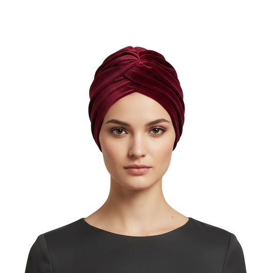 Woman wearing a red turban against a white background
