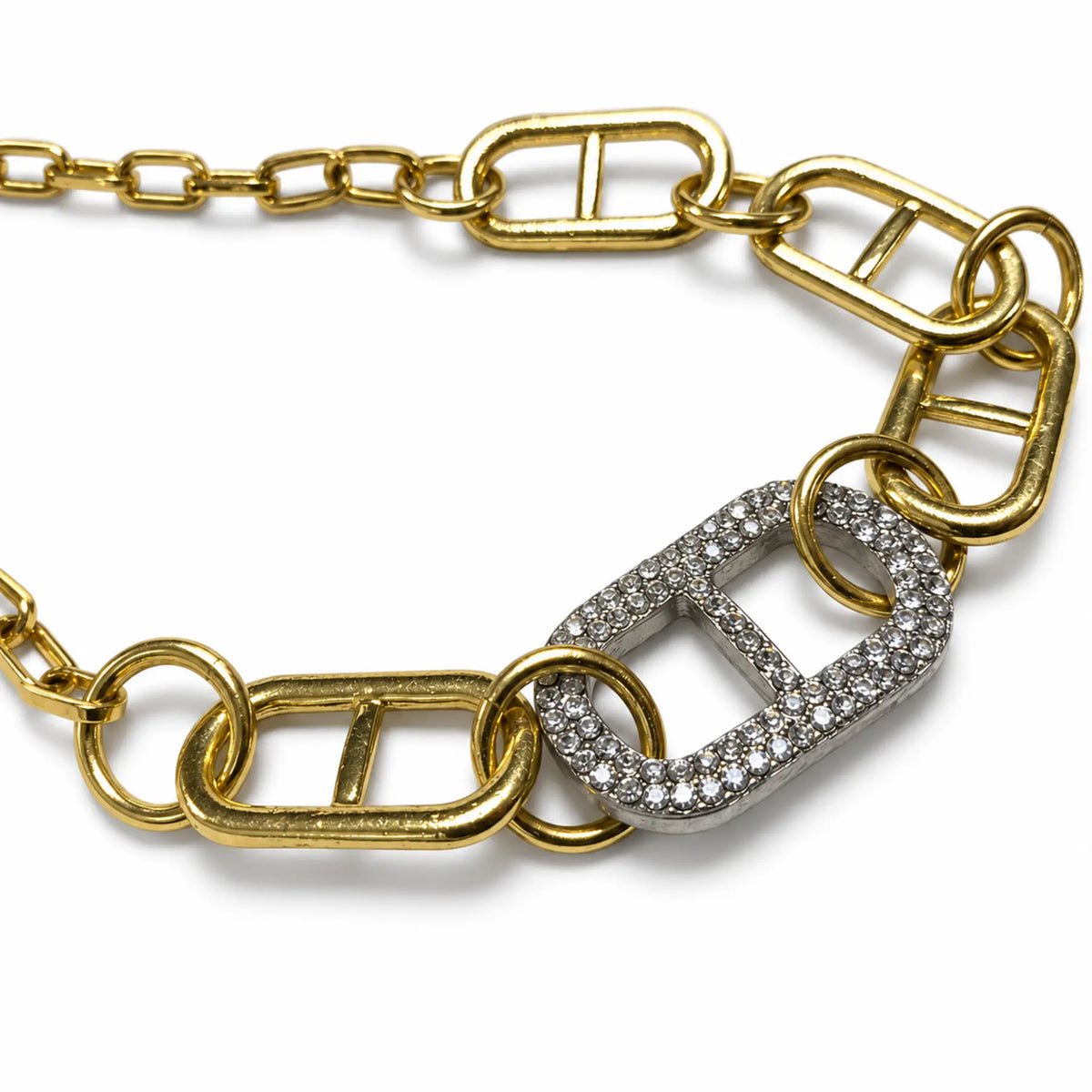 Close-up of silver crystal link on gold-tone mixed-link necklace