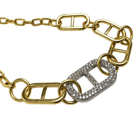 Close-up of silver crystal link on gold-tone mixed-link necklace