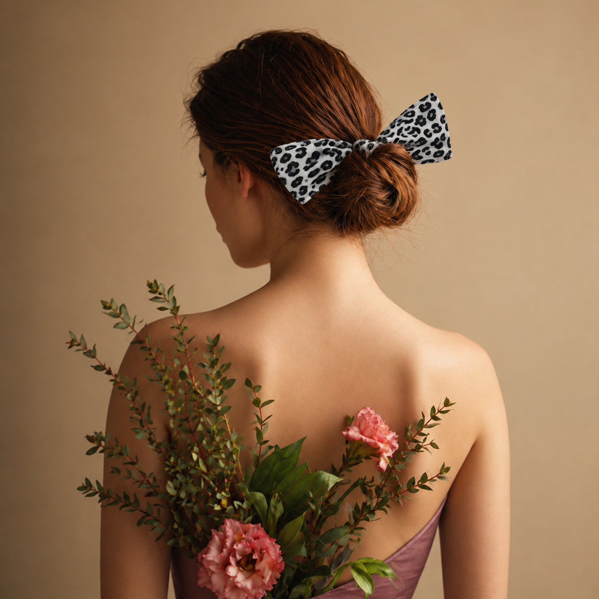 Woman wearing Migant black and white leopard bun wrap hairband