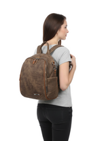 Load image into Gallery viewer, Woman wearing a brown backpack on a white background

