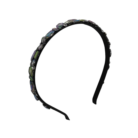 Black headband with decorative elements on a white surface