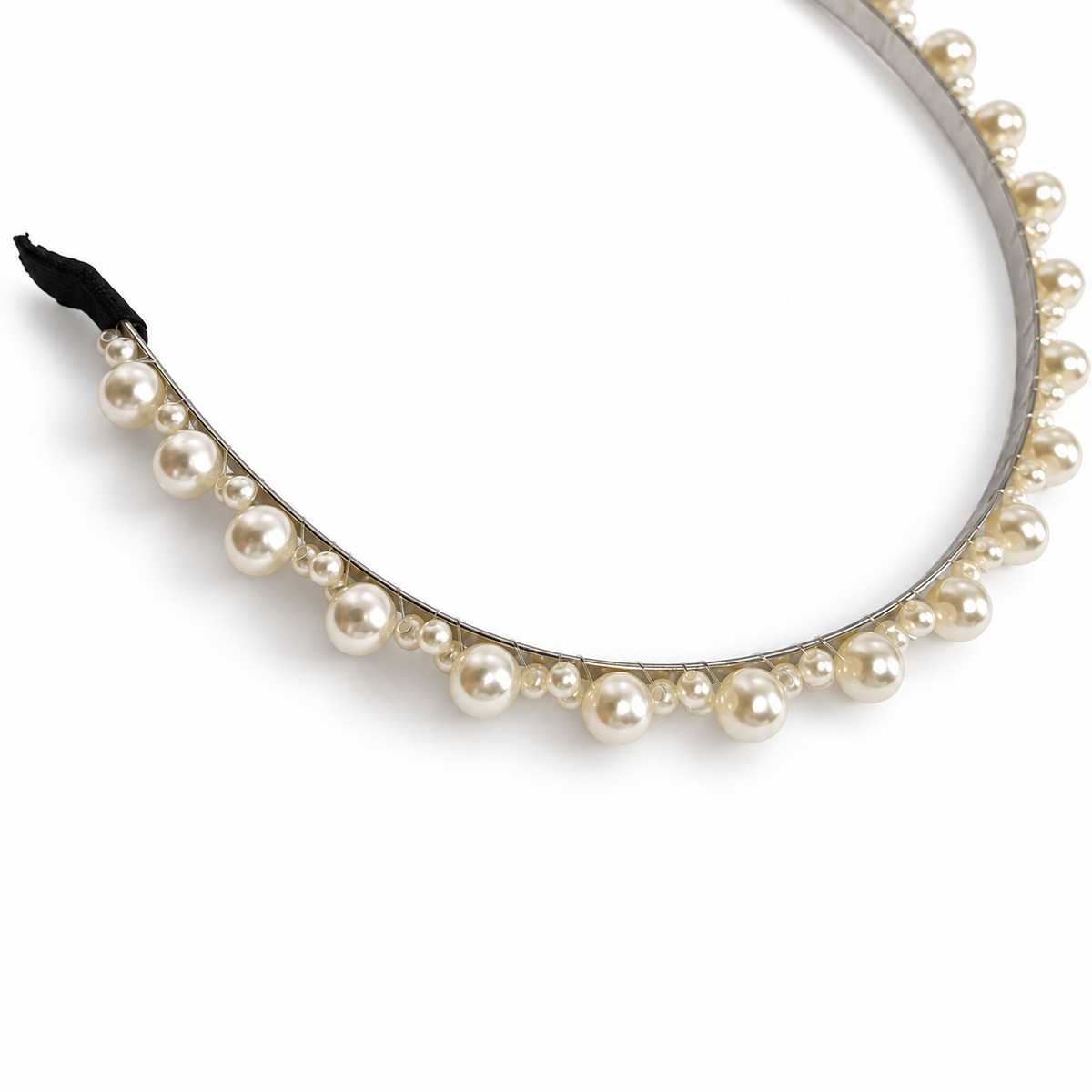 Close-up of alternating large and small ivory pearl-style beads on silver-tone headband